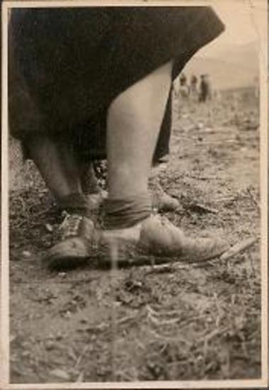 Mantinea. Woman's shoes covered with mud