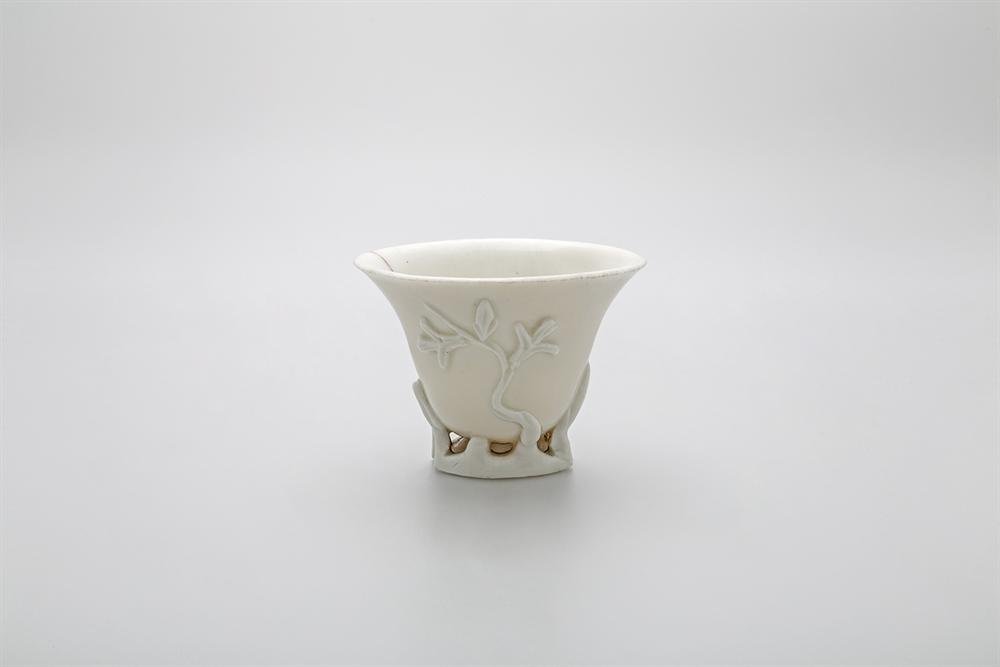 'Libation cup of white-glazed 'blanc de Chine' porcelain with moulded relief decoration