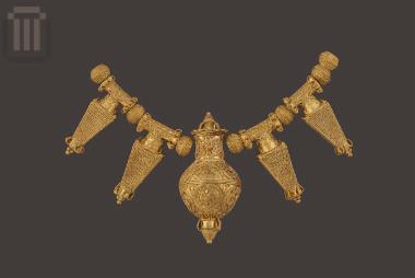 Gold pendant in the shape of a amphora with pointed base from a necklace