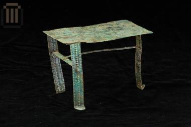 Bronze model of a three-legged table