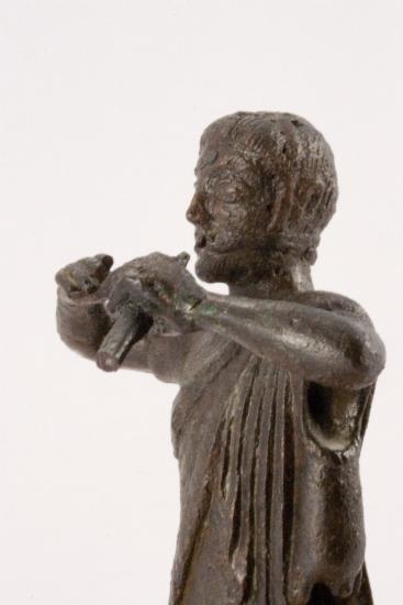 Bronze figurine of a flute player