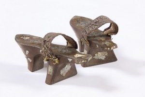 Pair of high-heeled wooden bath clogs, carved decoration, mother-of-pearl inlay of dove motifs, gold embroidered strap attached to the sole, probably belonged to a member of the the local Jewish community.