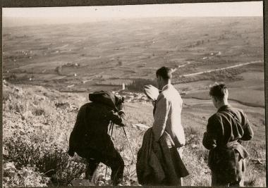 Three men, one with camera