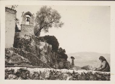 Leuca. Bell tower with old woman seated below