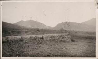 Phlius. Stone wall with mountains in the distance