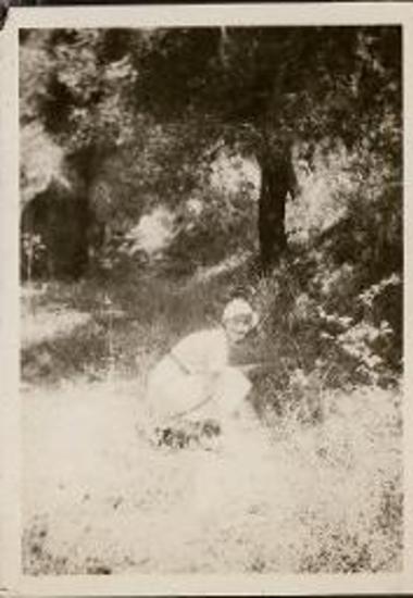 Olympia. Woman kneeling on the grass