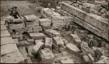 Delphi. Woman sitting on ruins
