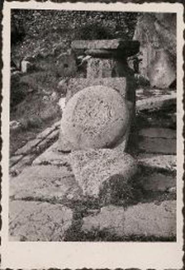 Delphi. Column base and round stones with carvings