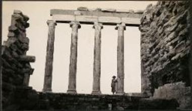 Woman standing by columns