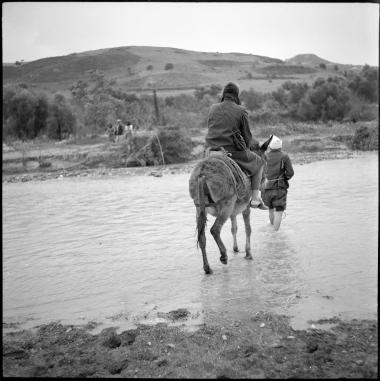 Hagia Triada. Crossing river on donkey