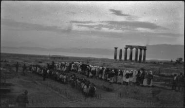 Corinth. People dancing,  temple of Apollo in the background