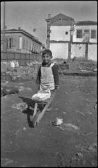 Agora Excavations. Little boy with wheel barrow