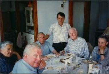 Richard Howland at the table with Christos and others