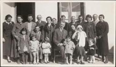 Family portait of the Lekkas family with Richard H. Howland at the christening of Lekkas's godchild