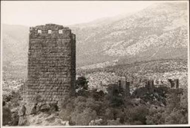 Orchomenos. Tower and fortified wall with mountains in the distance