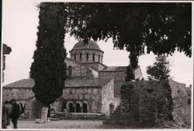 Byzantine church with big cypress tree in front