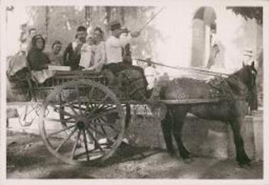 Village people on horse drawn cart