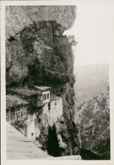 Small monastery hanging from a cliff like Meteora