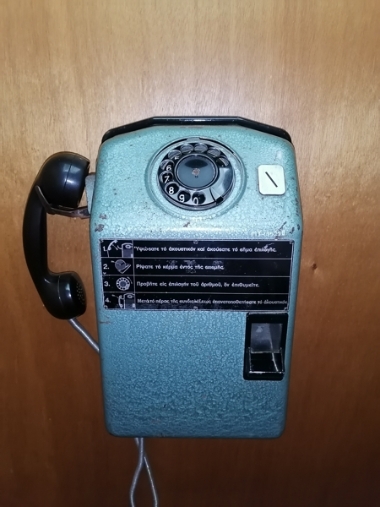 Wall mounted coin telephone.