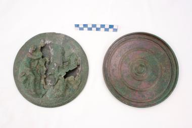 Bronze mirror with a decoration in relief