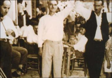 Lesbos Island (Ampeliko) Decade 1950: The musician Manolis Pantelelis (violin) with the dancer Koutsouradi or Tsourapas in a folk feast (glenti)