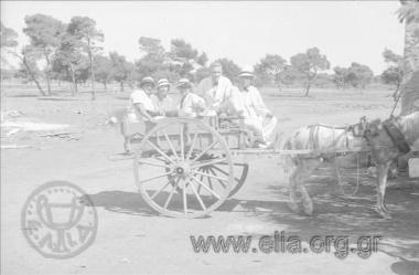 Iris Miliaraki with company in a carriage
