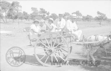 Iris Miliaraki with company in a carriage