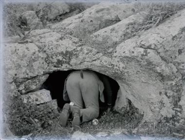Excursion of the Travel Club. A man entering a cave