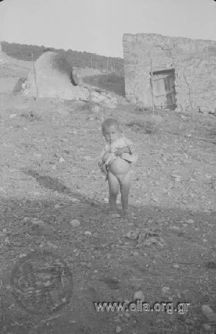 Child in front of a sham and a built furnace.