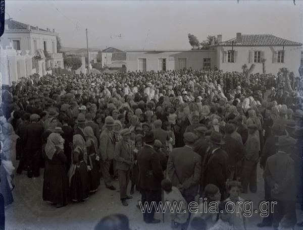 Assembled crowd in a village square.