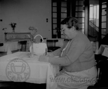 Iris writing in the dining room of Hotel Aigli