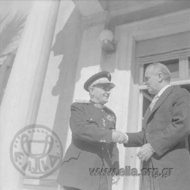 Prime Minister  Konstantinos Karamanlis and a general at the swearing-in of the government