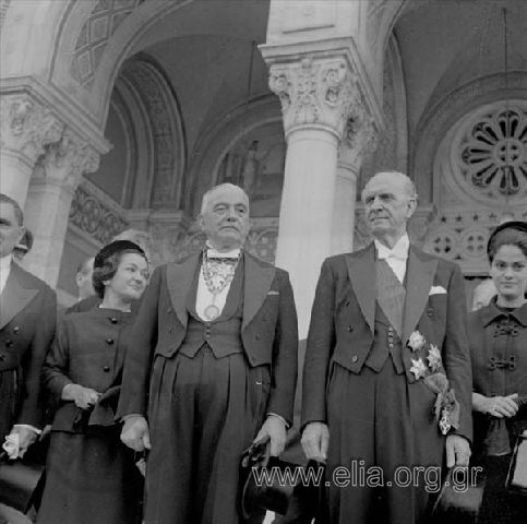 November 8. Georgios  Papandreou, President of the new government with Georgios Athanasiadis-Novas, Secretary of State, on the stairs of the Cathedral after the doxology for the swearing-in of the new government. At right, Marika Mitsotaki.