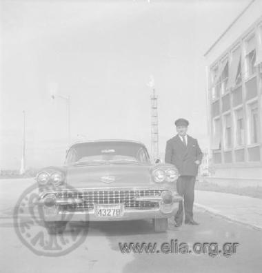 Employee of the Skaramangas Shipyards: driver next to the limousine.