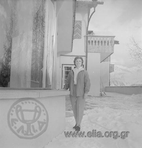 Evgenia Livanou, Stavros Niarchos' wife, posing outside of a swiss' chalet or hotel