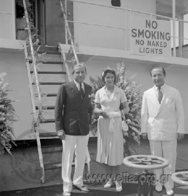Stavros Niarchos and his wife Evgenia Livanou on the deck of a ship awaiting the royal couple Pavlos-Friederiki.