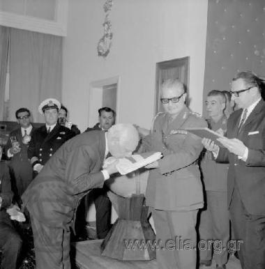 Ministry of Mercantile Marine, celebrating the recording of the two thousandth ocean-going ship in the Greek  shipping register. Shipowner receiving award  from the Regent, Lieutenant General  Georgios Zoitakis. On the right, the Minister  of Mercantile M
