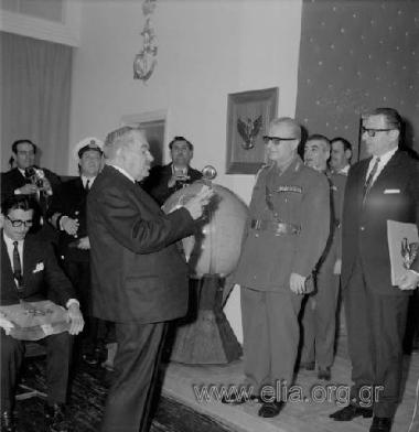 Ministry of Mercantile Marine, celebrating the recording of the two thousandth ocean-going ship in the Greek  shipping register. Shipowner receiving award  from the Regent, Lieutenant General  Georgios Zoitakis. On the right, the Minister  of Mercantile M