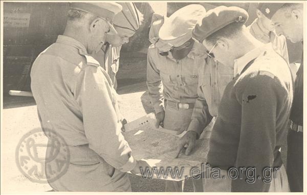 Servicemen studying a map.