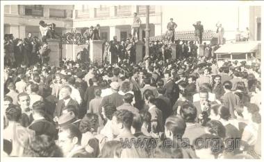Assembled crowd outside a building.