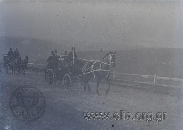 Coaches (with grooms - escorts) on a country road