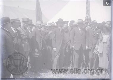 Minister for Social Relief, Health and Security Apostolos Doxiadis with members of the committee for refugee rehabilitaiton (?) and local autorities at a refugee camp