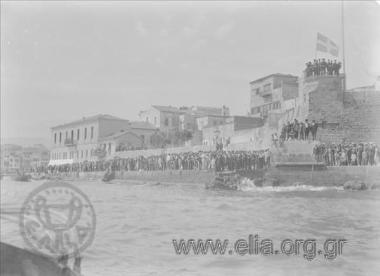 Ship pulling into port, crowd at the quay