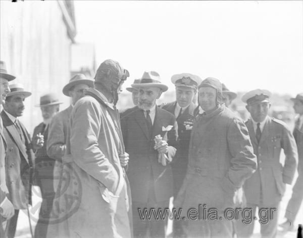 Admiral Chatzikyriakos (in civilian attire). Next to him an aviator (King Alexandros?) and a navy officer