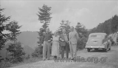 Eleni Makka, Tonis and Nikos Pagkousis next to a car.