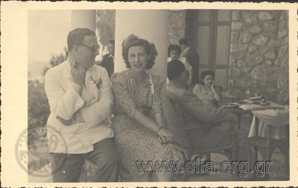 Ioulia Glypti and a man (Fredino) on a veranda of a coffeehouse