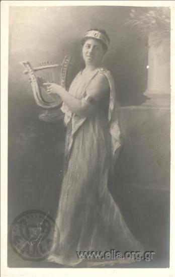 Aikaterini Zlatanou dressed in ancient Greek  costume, holding a harp.