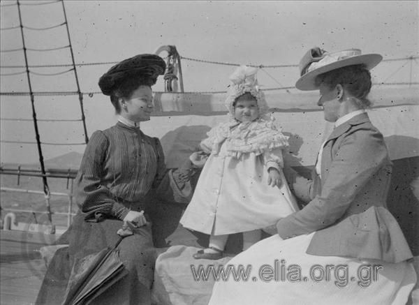Two women and a baby on board vessel Amphitrite