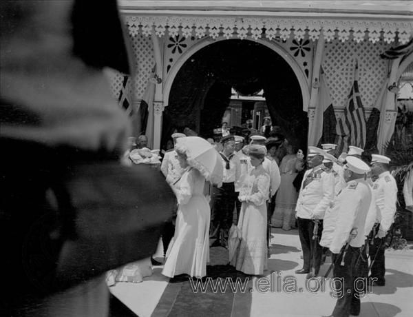 Queen Olga saluting officials.