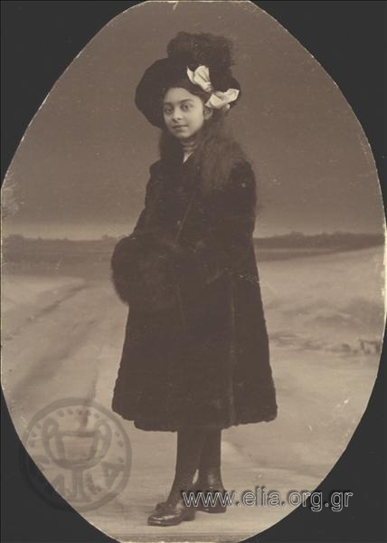 Portrait of girl with coat and hat.